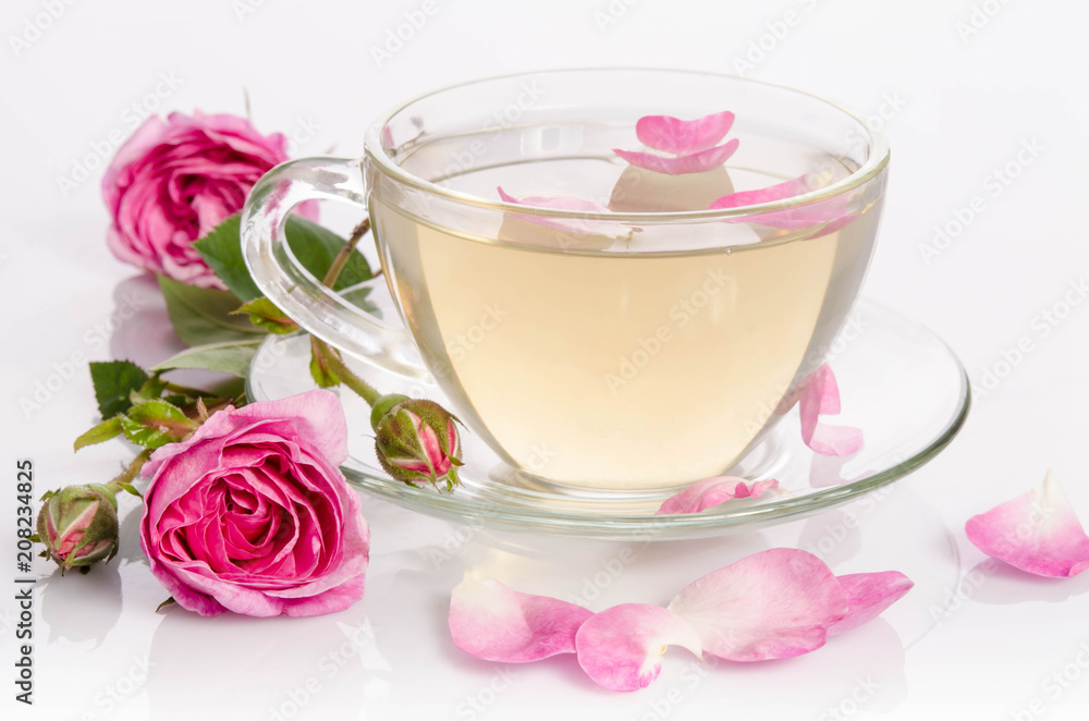 Glass cup of Tea with roses and petals