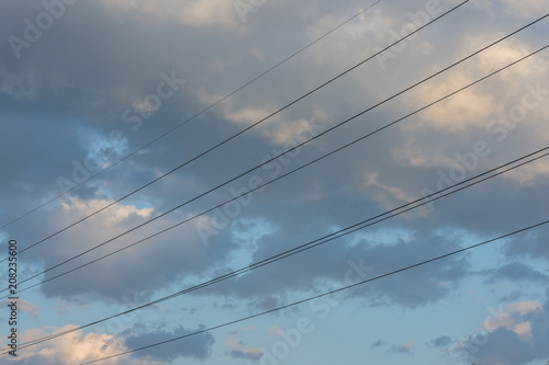 Electric wires with blue sky and clouds on sunset. Industrial concept. Background.