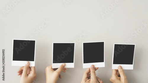 Hands holding blank photo frame