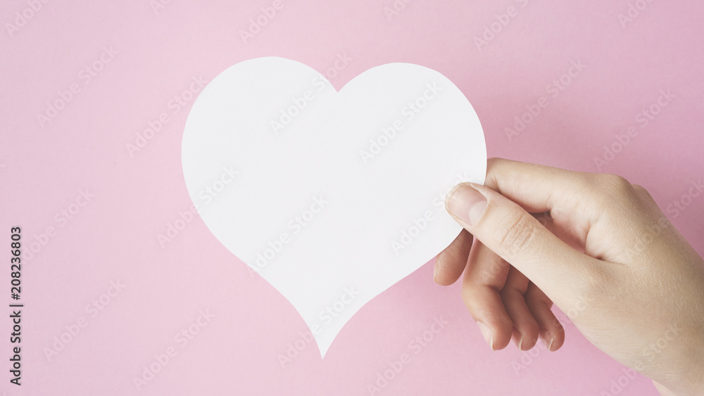 Hand holding heart shape card Hand holding heart shape card