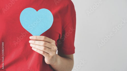 Hand holding heart shape card