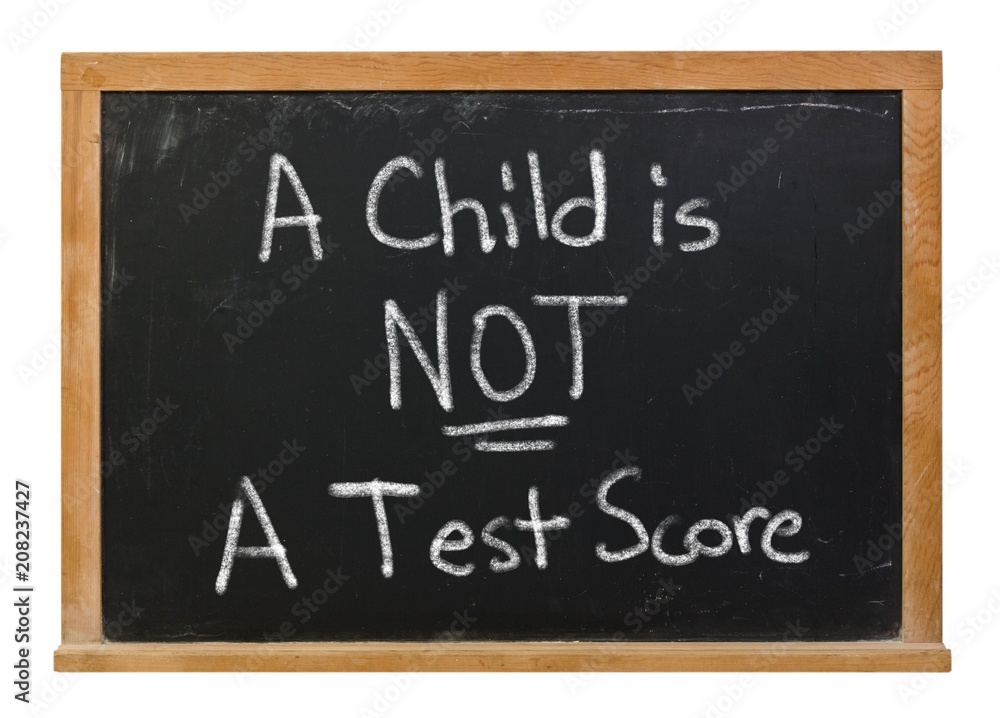A child is not a test score written in white chalk on a black chalkboard isolated on white A child is not a test score written in white chalk on a black chalkboard isolated on white