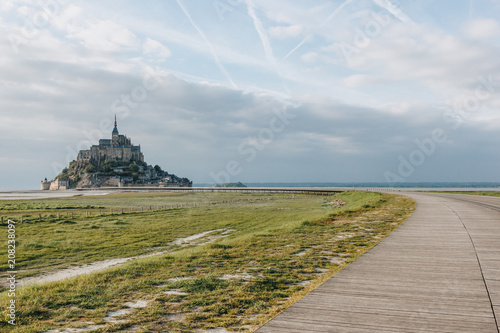 beautiful view of famous mont saint michel and walkway at sea coast  normandy  france
