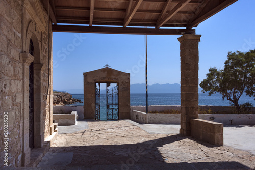 Greece, Aegina: Small church chapel door on the coast of the famous Greek island with ocean, horizon and blue water in the background - concept travel  ocean leisure religion Christianity historic photo