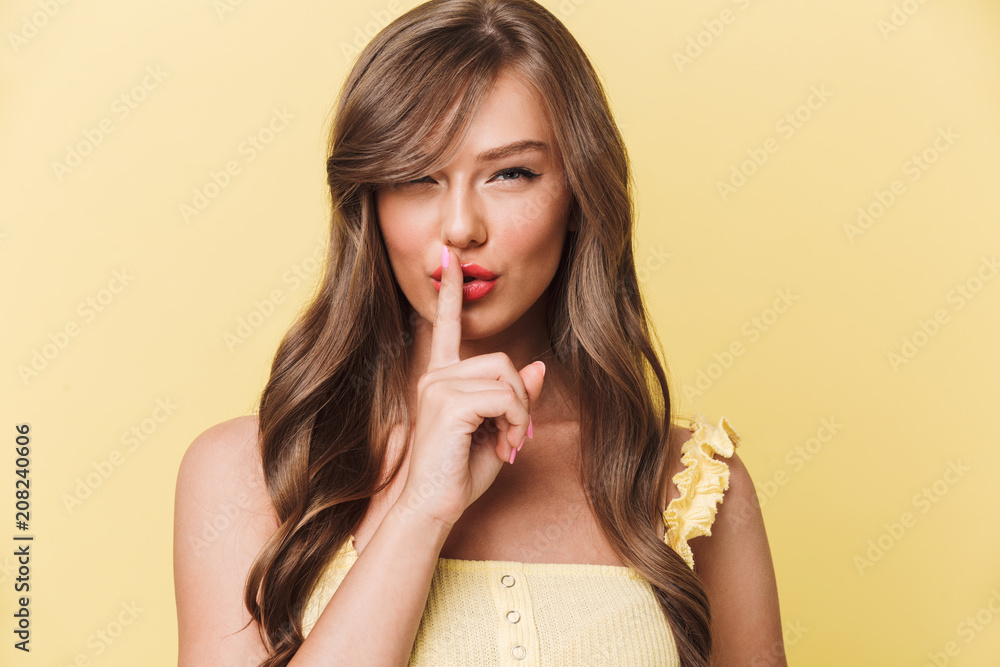 Serious young pretty woman showing silence gesture. Serious young pretty woman showing silence gesture.