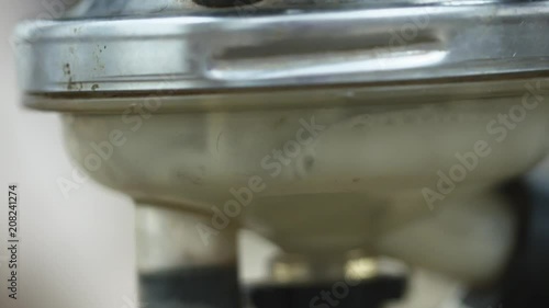 Fresh cow's milk poures into steal and plastic modern milking machine. Milking process. Macro close up. photo