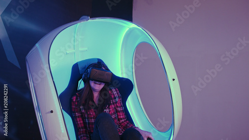 Excited young girl enjoying virtual reality attraction