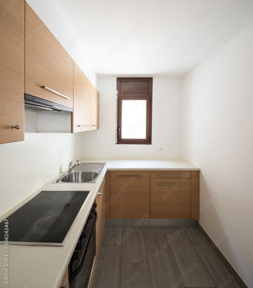Modern kitchen in wood and white walls, small window Modern kitchen in wood and white walls, small window