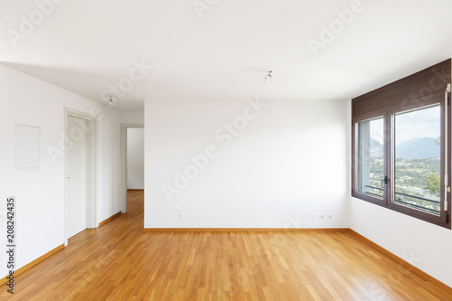 White empty room with parquet in modern apartment