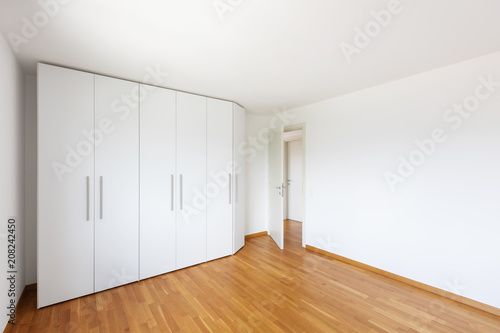 Wallpaper Mural White empty room with large white wardrobe and open door on the corridor Torontodigital.ca