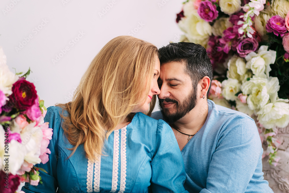 Happy kissing couple.Valentine's day,love and relationship concept.Flowers background.