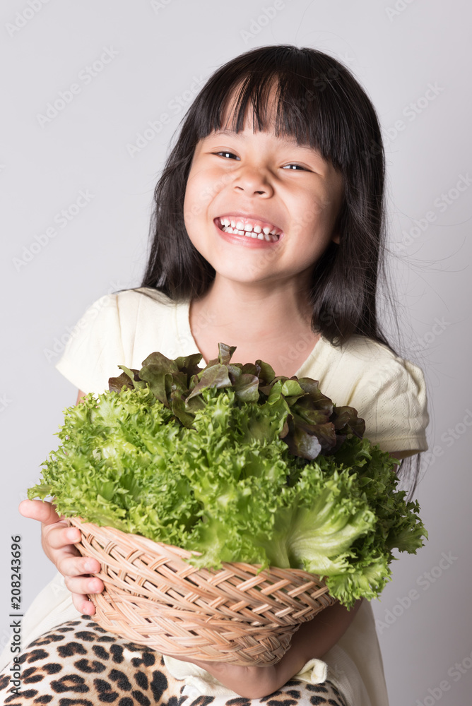 beautiful little girl with vegetables on a white background beautiful little girl with vegetables on a white background