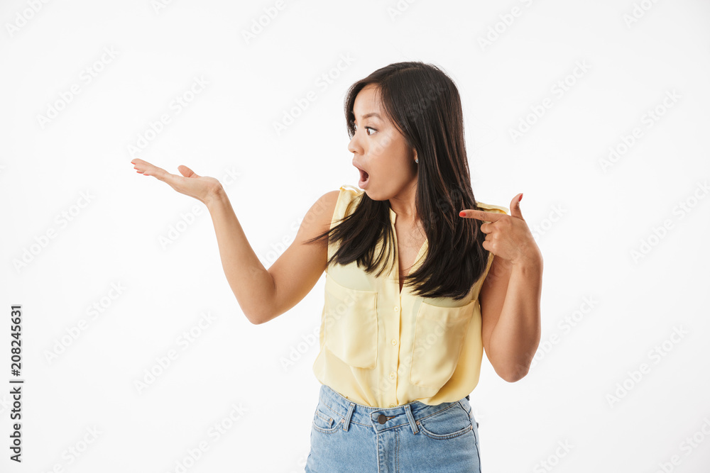 Excited young asian woman pointing. Excited young asian woman pointing.