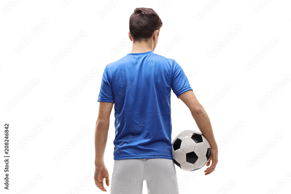 Obraz premium Rear view shot of a teenage soccer player holding a football