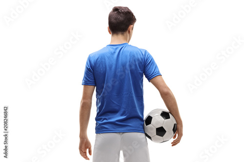 Rear view shot of a teenage soccer player holding a football