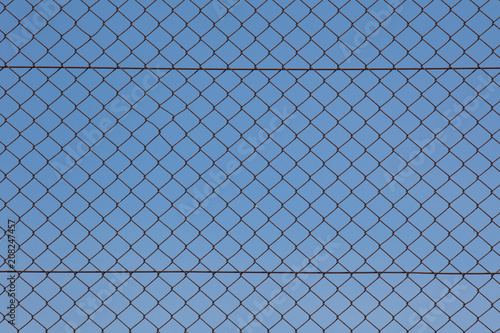 Metal fence and blue sky background