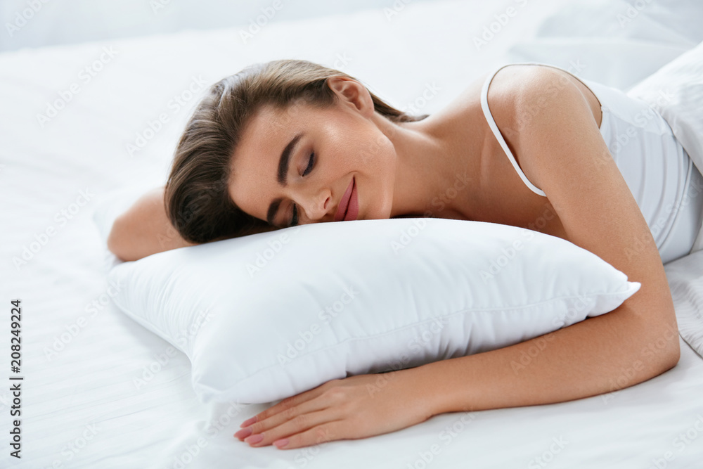 Soft Pillow. Female Sleeping In Bed On White Bedding Soft Pillow. Female Sleeping In Bed On White Bedding