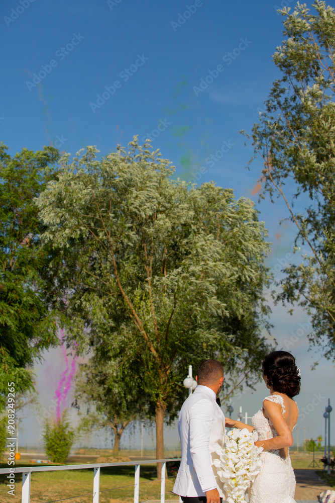 Romanic wedding couple posing in park Romanic wedding couple posing in park