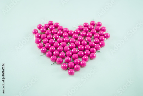 Collection of pink push pins. Heart shape