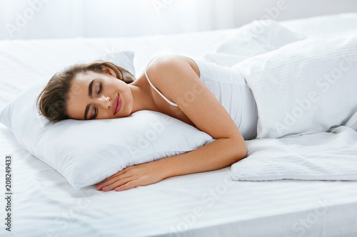 Soft Pillow. Female Sleeping In Bed On White Bedding