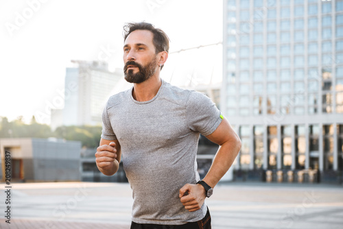 Handsome strong mature sportsman running