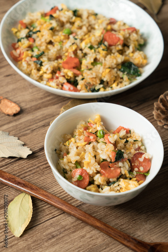 Fried rice with egg and wood grain background