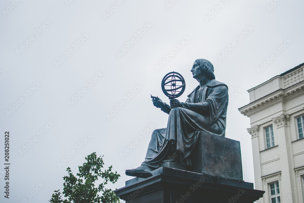 Fototapeta premium Poland's capital Warsaw on early August morning. Central part of the city. Monument to famous Polish scientist Nicolaus Copernicus