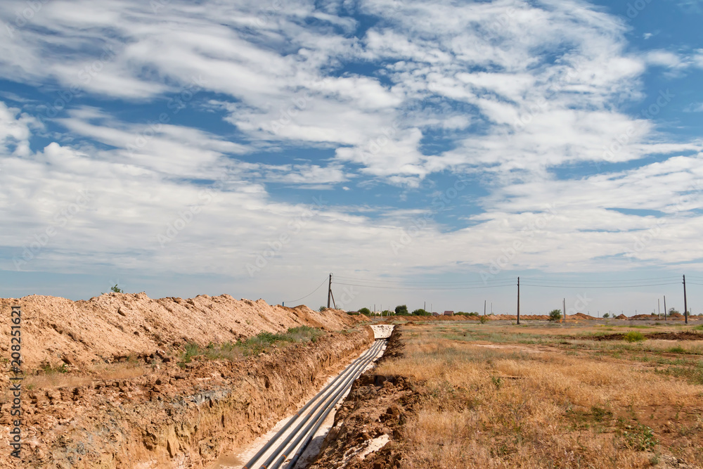 Pipelines laid on sand filling at the bottom of trench