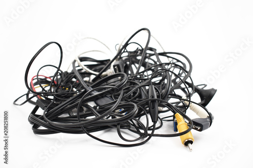 Tangled cables and connectors stock images. Tangle of cables on a white background. Plastic electronic waste. Pile of cables and connectors