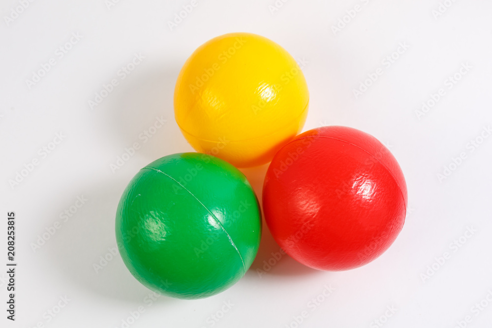 educational kids colored plastic balls toys on white background.