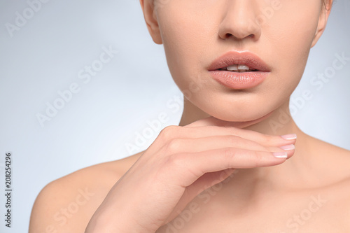 Beautiful young woman with natural makeup on light background  closeup