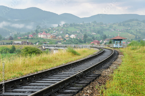 The railroad runs through the bridge.