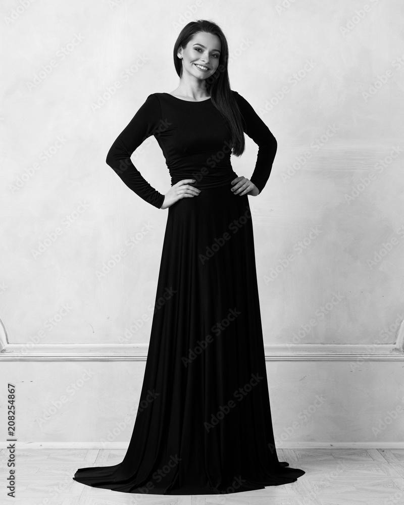 Young woman with long brunette hair dressed in elegant evening black ...