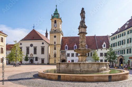 Bratislava, Slovakia - May 24, 2018: People near Roland Fountain at Main Square (Hlavne namestie) in Bratislava Old Town. Fountain construction was ordered in 1572 to provide public water supply.