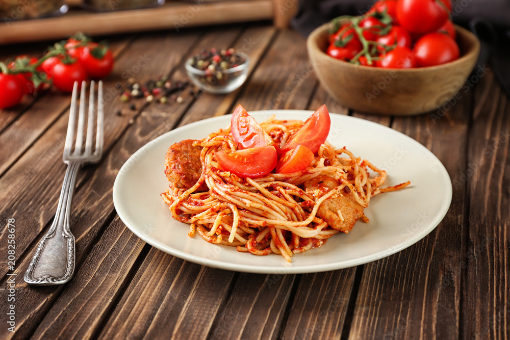 Plate of delicious pasta with tomato sauce on table Plate of delicious pasta with tomato sauce on table