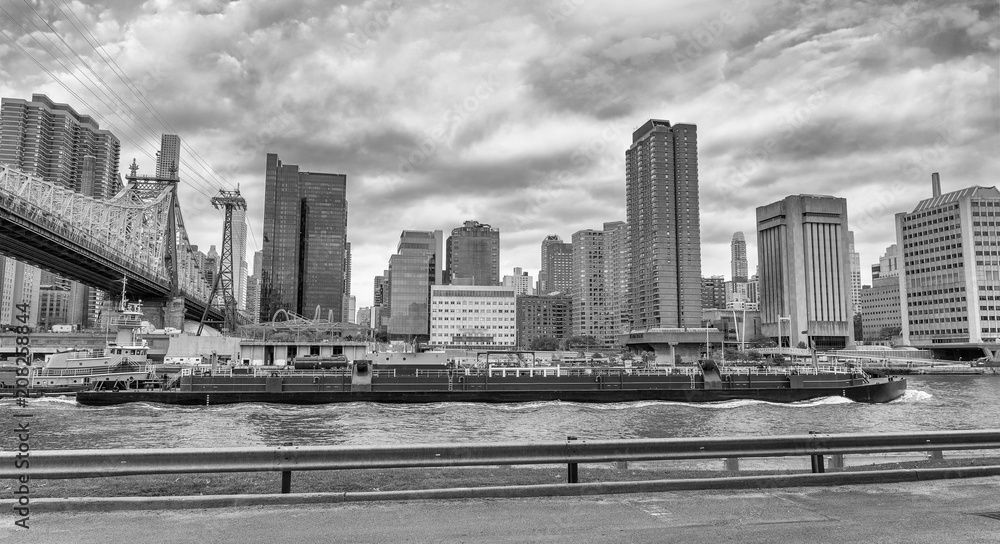 Manhattan and East River view from Roosevelt Island on a cloudy day