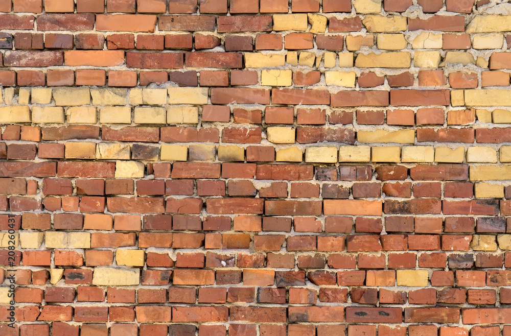Fototapeta premium Wall with red and yellow bricks