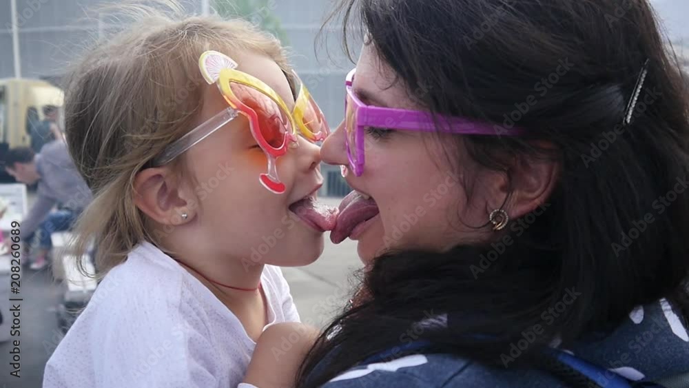 Weekend family amuse nanny with child girl on hands in funny glasses show tongue kiss and smile Stock ビデオ | Adobe Stock 