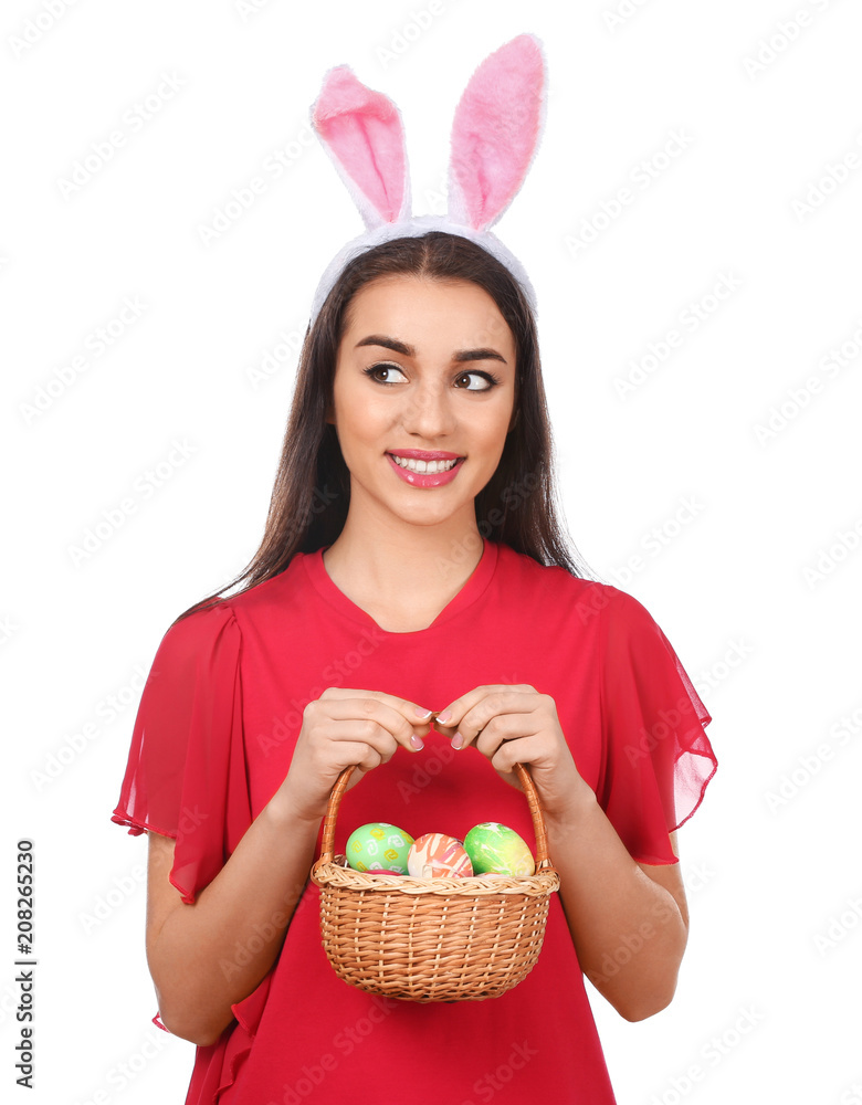Beautiful young woman with Easter eggs and bunny ears on white background Beautiful young woman with Easter eggs and bunny ears on white background