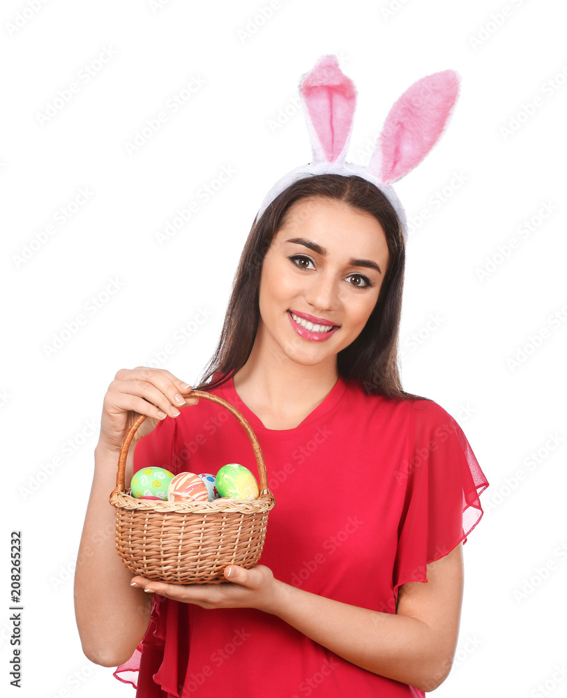 Beautiful young woman with Easter eggs and bunny ears on white background Beautiful young woman with Easter eggs and bunny ears on white background