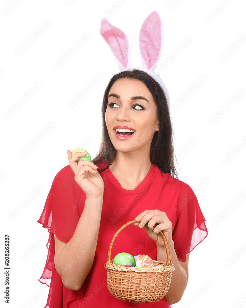 Beautiful young woman with Easter eggs and bunny ears on white background Beautiful young woman with Easter eggs and bunny ears on white background