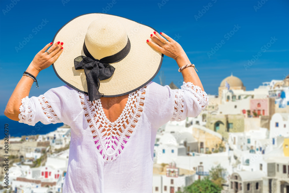 Fototapeta premium Woman looking at the view in Santorini