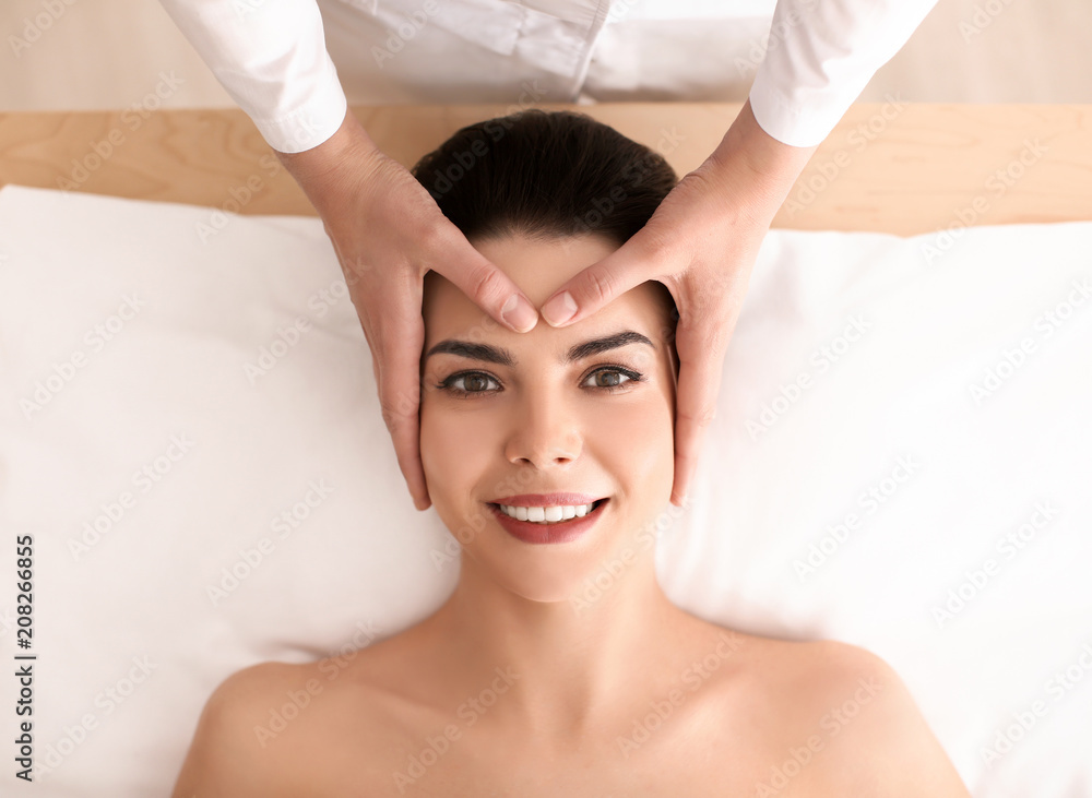 Young woman enjoying facial massage in spa salon Young woman enjoying facial massage in spa salon