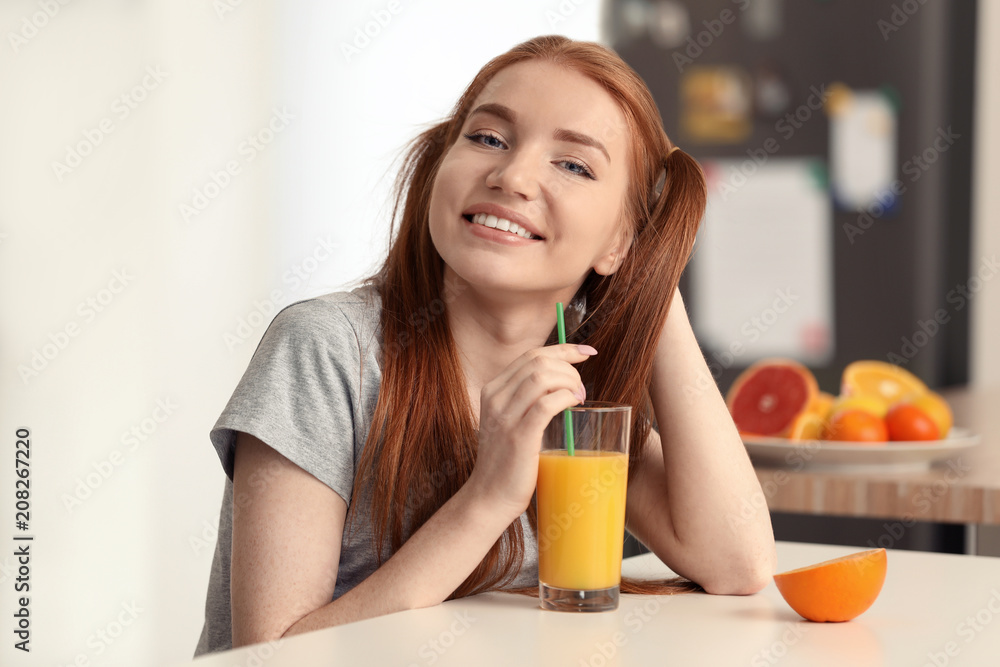 Beautiful young woman drinking citrus juice in kitchen Beautiful young woman drinking citrus juice in kitchen