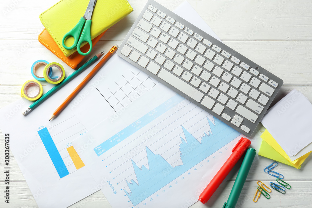 Computer keyboard, documents and stationery on wooden background, flat lay. Workplace table composition Computer keyboard, documents and stationery on wooden background, flat lay. Workplace table composition