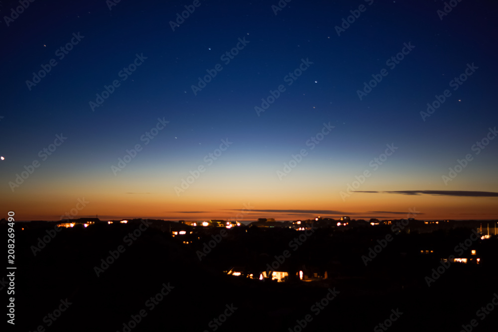 City landscape at nigh with sky filled with stars. City landscape at nigh with sky filled with stars.