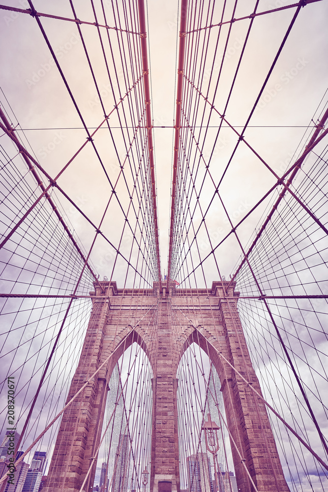 Obraz premium Looking up at the Brooklyn Bridge, color toned picture, New York City, USA.