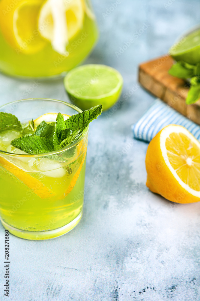 Fresh mojito cocktail on background with wooden board full of lime and mint. Coctail with lime and lemon. Place for text. Fresh mojito cocktail on background with wooden board full of lime and mint. Coctail with lime and lemon. Place for text.