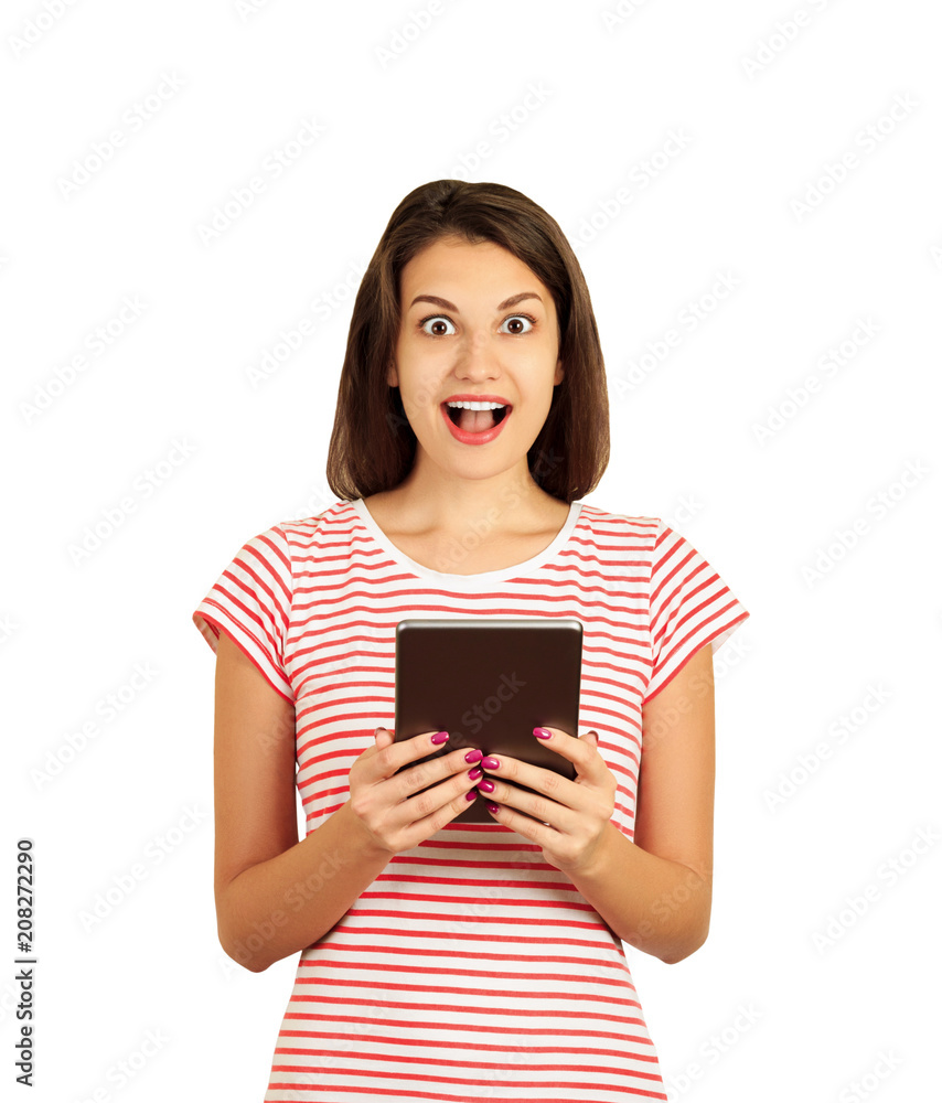 Portrait of surprised and impressed woman with widened eyes and opened mouth, stunned because of something she sees on screen of tablet. emotional girl isolated on white background Portrait of surprised and impressed woman with widened eyes and opened mouth, stunned because of something she sees on screen of tablet. emotional girl isolated on white background