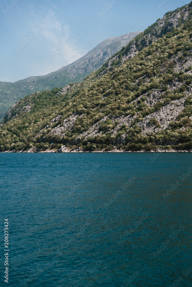 Blue Ocean Water and Mountains in Montenegro along the Coast Blue Ocean Water and Mountains in Montenegro along the Coast